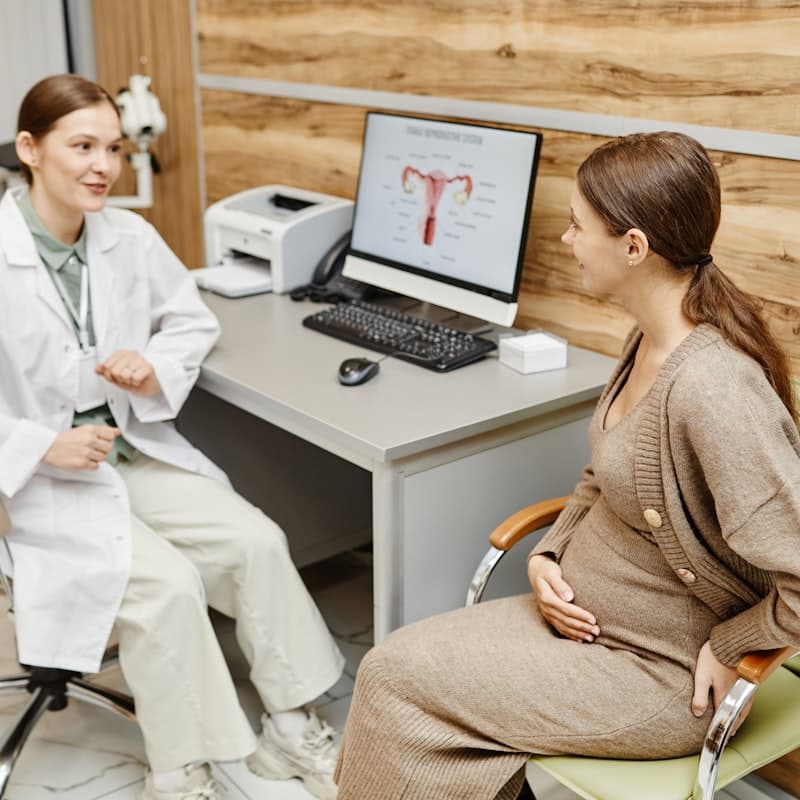Obstetrician talking with a pregnant woman during a consultation